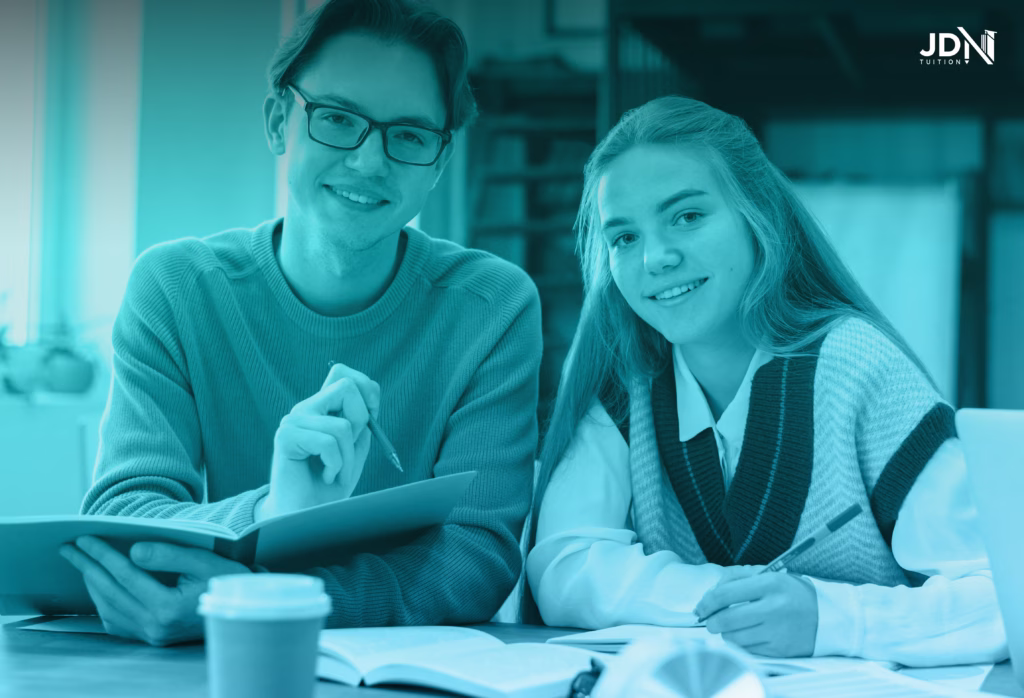 A focused high school student and tutor analysing a textbook together.